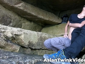 Young white and Asian gay couple makes love in a natural environment in the sea.