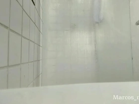 Solo shower scene in a dirty hotel bathroom in Barcelona.