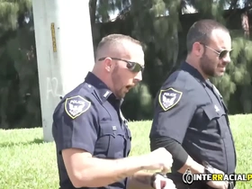 Gay police officers rough up a car thief and give him anal sex through an open window.